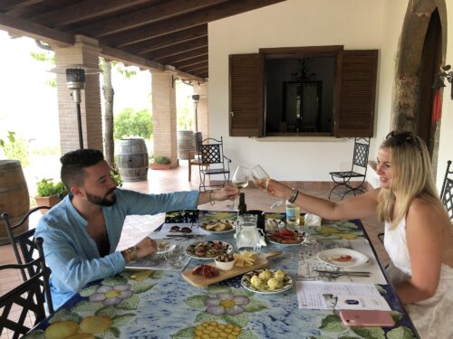 A couple raising their glasses at the winery